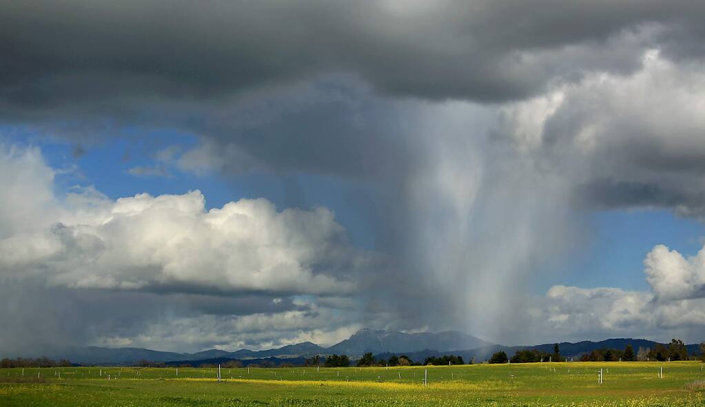 A hailstorm rolls over the Santa Rosa Plain with Mount St. Helena in the background in 2013. (KENT PORTER/ PD FILE)