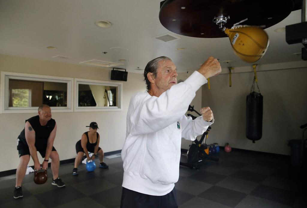 PHOTO: 1 by BETH SCHLANKER / The Press Democrat -HITTING THE BAG: Ted Elliott, who was paralyzed by a stroke two years ago, works out last month at Montecito Heights Health and Racquet Club in Santa Rosa.