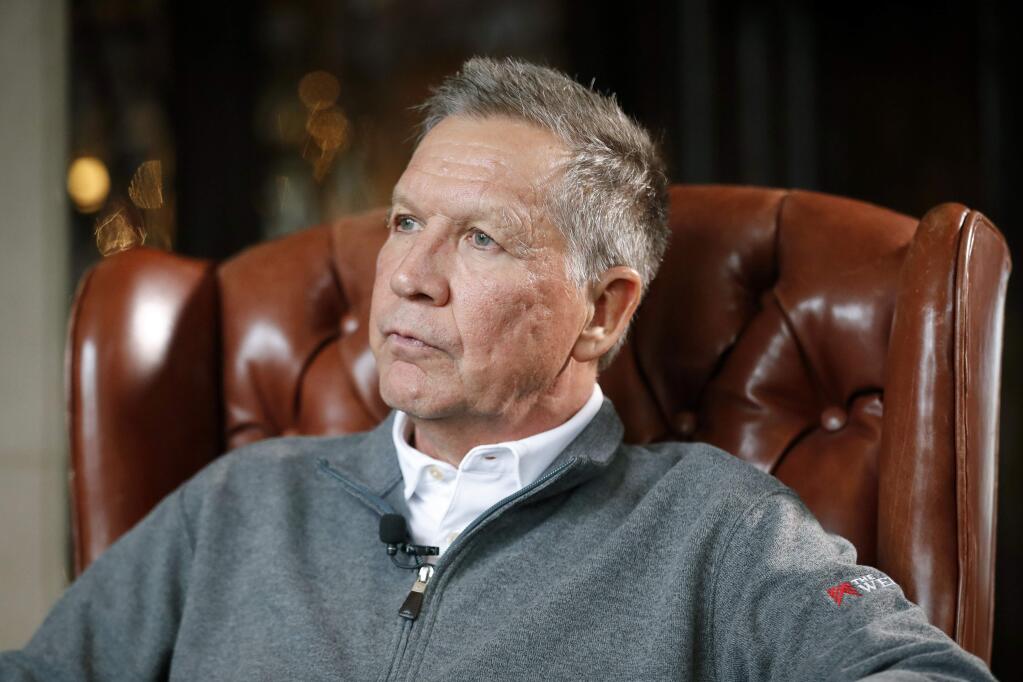 FILE - In a Dec. 13, 2018, file photo, then-Ohio Gov. John Kasich sits for an interview with The Associated Press in Columbus. Kasich, who ran against President Donald Trump in the 2016 Republican primary, says he supports impeachment. Kasich said Friday, Oct. 18, 2019, on CNN that the final straw was when acting White House chief of staff Mick Mulvaney acknowledged that Trump's decision to hold up military aid to Ukraine was linked to his demand that Kyiv investigate the Democratic National Committee and the 2016 U.S. presidential campaign. (AP Photo/John Minchillo, File)