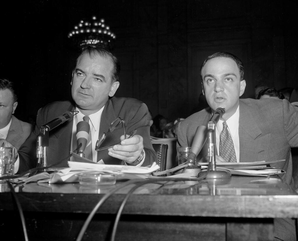 Sen. Joe McCarthy sits alongside Roy Cohn during the June 11, 1954 proceedings in the Senate hearings on McCarthy's dispute with the Army. (HENRY GRIFFIN / Associated Press)