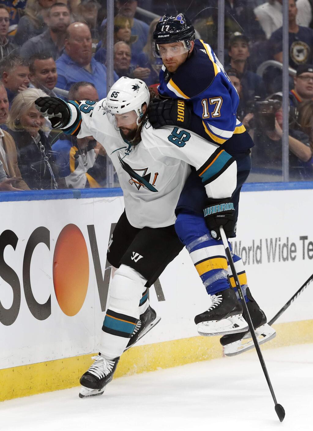 St. Louis Blues left wing Jaden Schwartz (17) lands on the back of San Jose Sharks defenseman Erik Karlsson (65), of Sweden, during the third period in Game 3 of the NHL hockey Stanley Cup Western Conference final series Wednesday, May 15, 2019, in St. Louis. (AP Photo/Jeff Roberson)