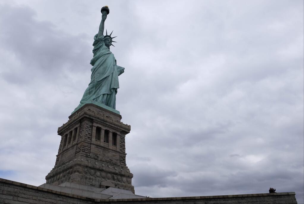 FILE - In this April 8, 2016 file photo, the Statue of Liberty is seen on Liberty Island in New York. For several hours, Lady Liberty didn't shine so brightly. The famed The Statue of Liberty was temporarily in the dark Tuesday night, March 7, 2017, after what a spokesman calls an 'unplanned outage.' (AP Photo/Charles Dharapak, File)