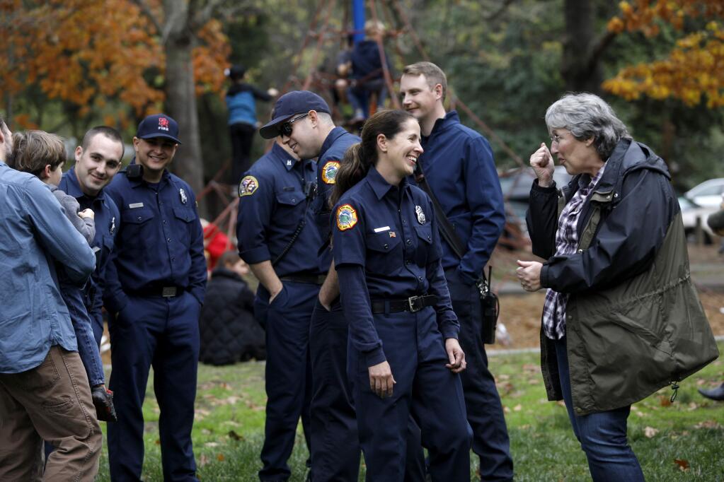 Kenwood volunteer firefighter Jen Demarest, center, talks with Janet Uboldi, right, during a community potluck to thank the Kenwood firefighters at Plaza Park in Kenwood, on Sunday, November 12, 2017. (BETH SCHLANKER/ The Press Democrat)