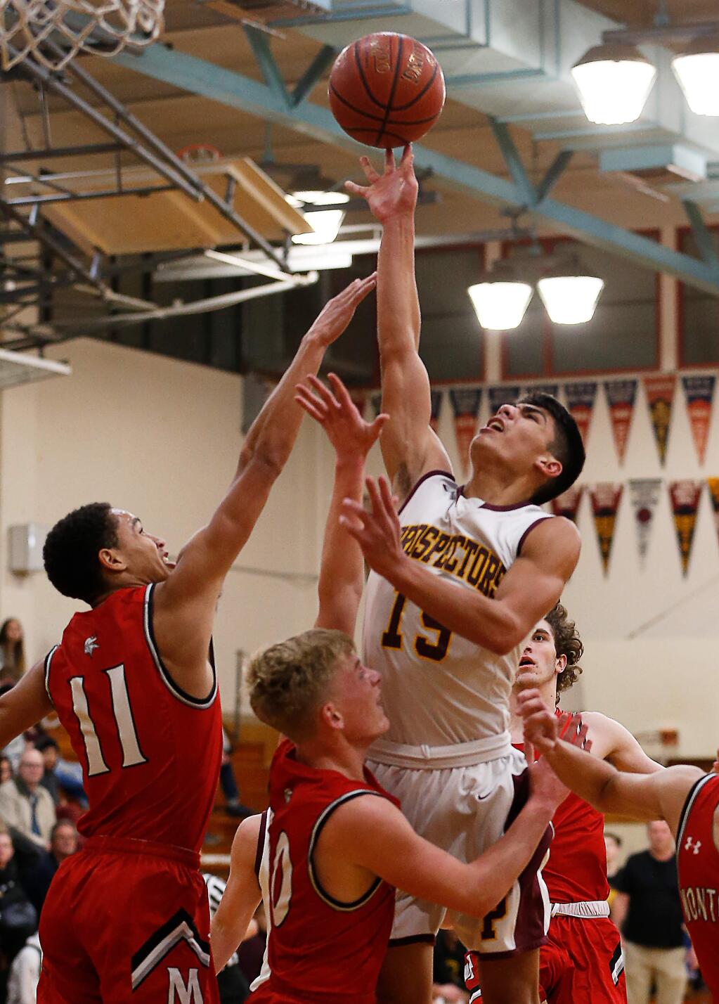 Piner's Adonis Gutierrez, right, shoots and scores over Montgomery's Cole Hallin and Devin Ramirez, far left, during the first half on Tuesday, Jan. 7, 2020. (Alvin Jornada / The Press Democrat)