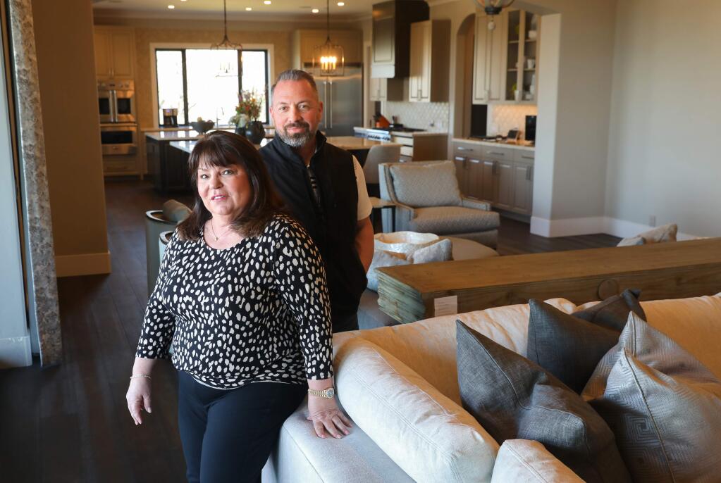 Homeowner Pollie Barnes with her builder Dustin Baker, president of Precision Builders Corporation, in her newly rebuilt Fountaingrove area home, in Santa Rosa. Barnes' home is the one thousandth Santa Rosa home to be rebuilt from the October 2017 wildfires.(Christopher Chung/ The Press Democrat)