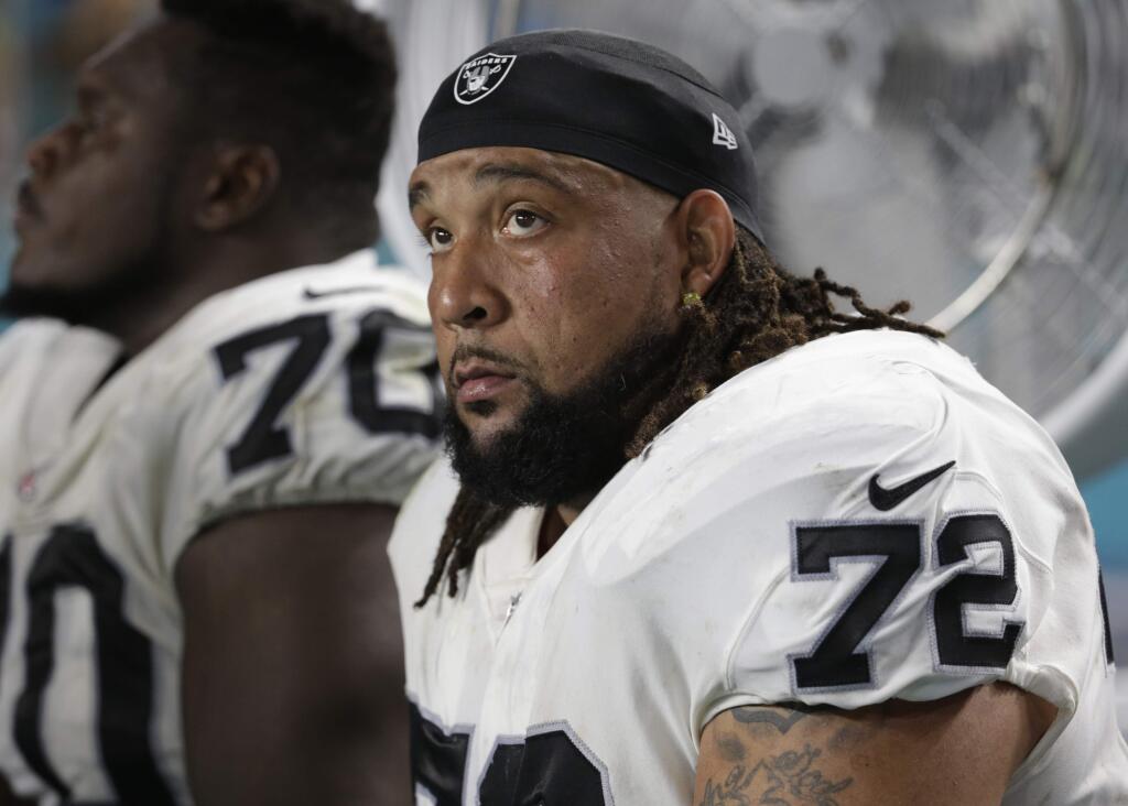 Oakland Raiders offensive tackle Donald Penn sits on the sidelines during the first half against the Miami Dolphins, Sunday, Nov. 5, 2017, in Miami Gardens, Fla. (AP Photo/Lynne Sladky)