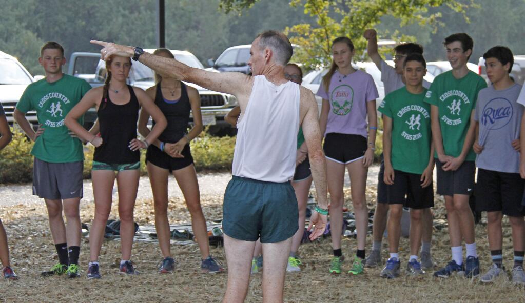 Bill Hoban/Index-TribuneCross country Coach John Litzenberg gives last- minute instructions to his team before the annual Alumni Meet Wednesday afternoon at Maxwell Farms Regional Park.