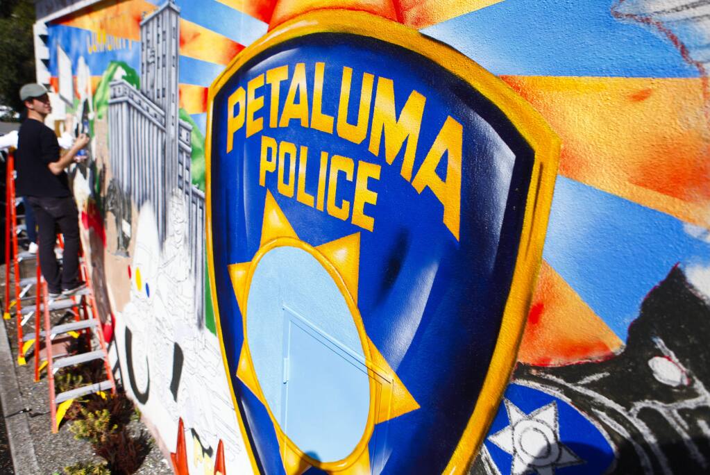 Petaluma, CA, USA. Monday, February 27, 2017._ Local artist, Maxfield Bala paints a mural at the Petaluma Police Department. (CRISSY PASCUAL/ARGUS-COURIER STAFF)