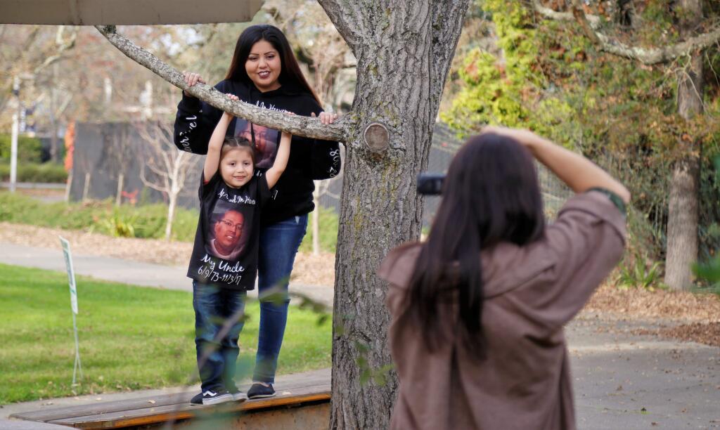 Monica James and her son Koda pose for photographer Katharina Kienboeck. The Santa Rosa Junior College photography department held free family portraits for Sonoma County fire victims, Saturday, Dec. 2nd at the SRJC. (Will Bucquoy/For the Press Democrat).