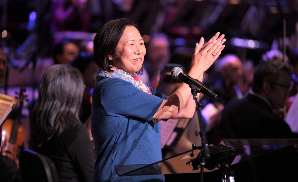 SSU President Dr. Judy Sakaki applauds the Santa Rosa Symphony as she welcomes guests attending the 4th of July Fireworks Spectacular at Sonoma State University's Green Music Center in Rohnert Park, California on July 4, 2018. (WILL BUCQUOY/ FOR THE PD)