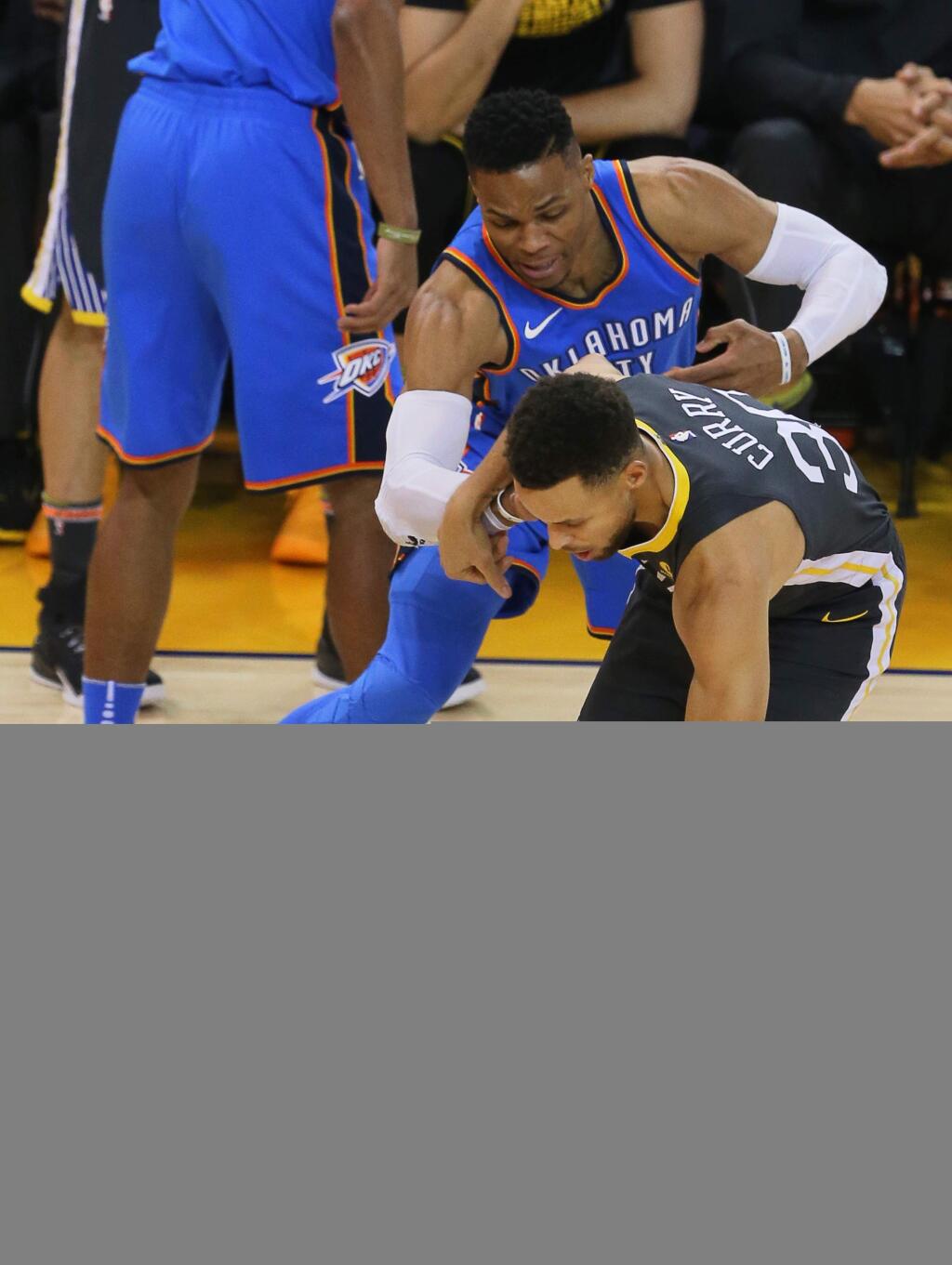 Golden State Warriors guard Stephen Curry loses the ball while trying to drive past Oklahoma City Thunder guard Russell Westbrook in Oakland on Tuesday, February 6, 2018. (Christopher Chung/ The Press Democrat)
