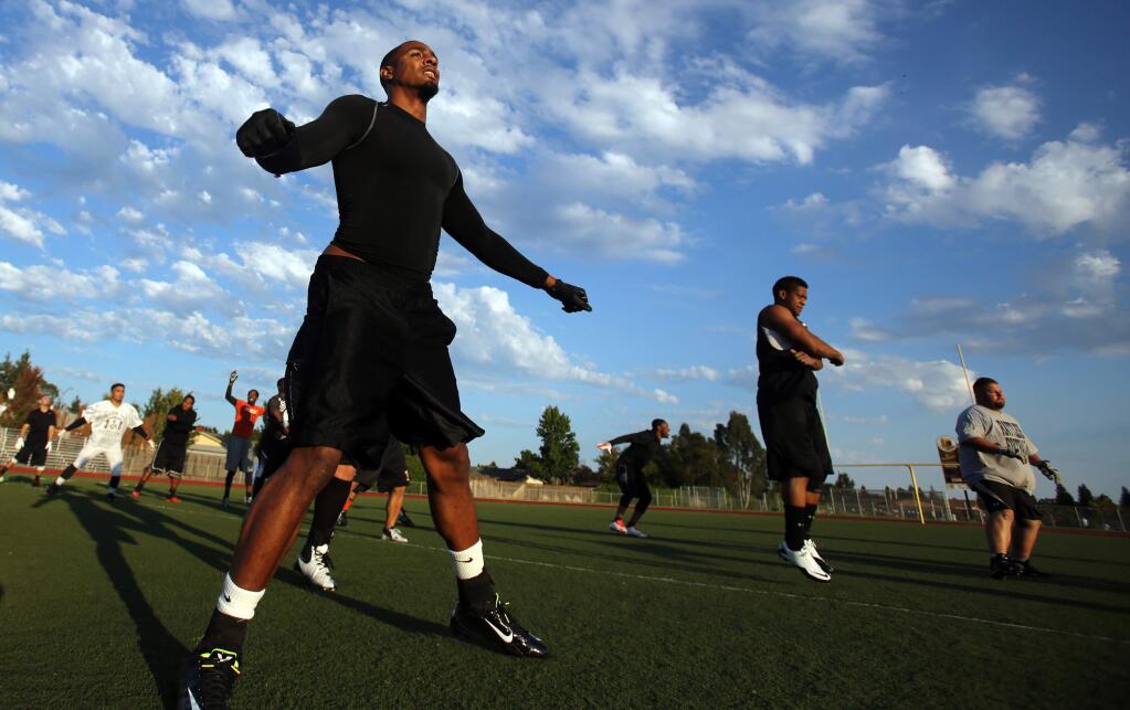 The North Bay Rattlers Jesse Martinez, left, warms up with the team during practice at Piner High School, Tuesday, July 29, 2014. (Crista Jeremiason / The Press Democrat)