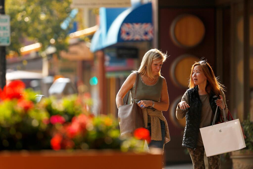 Karen Tang, right, whose home in the Coffey Lane neighborhood was destroyed by the Tubbs fire three days ago, goes shopping with her best friend, Lesley Carrier of Petaluma, in order to replace some of her lost belongings, in downtown Santa Rosa, California, on Thursday, October 12, 2017. (Alvin Jornada / The Press Democrat)