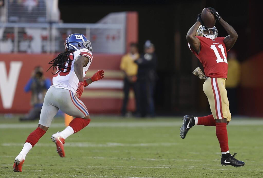 San Francisco 49ers wide receiver Marquise Goodwin catches a touchdown pass in front of New York Giants cornerback Janoris Jenkins, left, during the first half Sunday, Nov. 12, 2017. (AP Photo/Ben Margot)