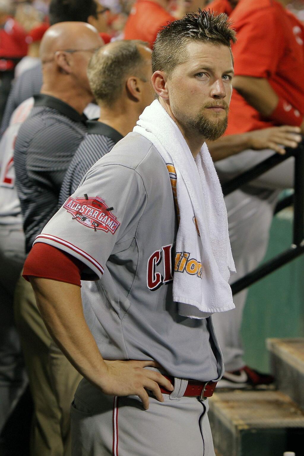Cincinnati Reds starting pitcher Mike Leake watches from the dugout during the ninth inning of a game against the St. Louis Cardinals Tuesday, July 28, 2015, in St. Louis. (AP Photo/Scott Kane)