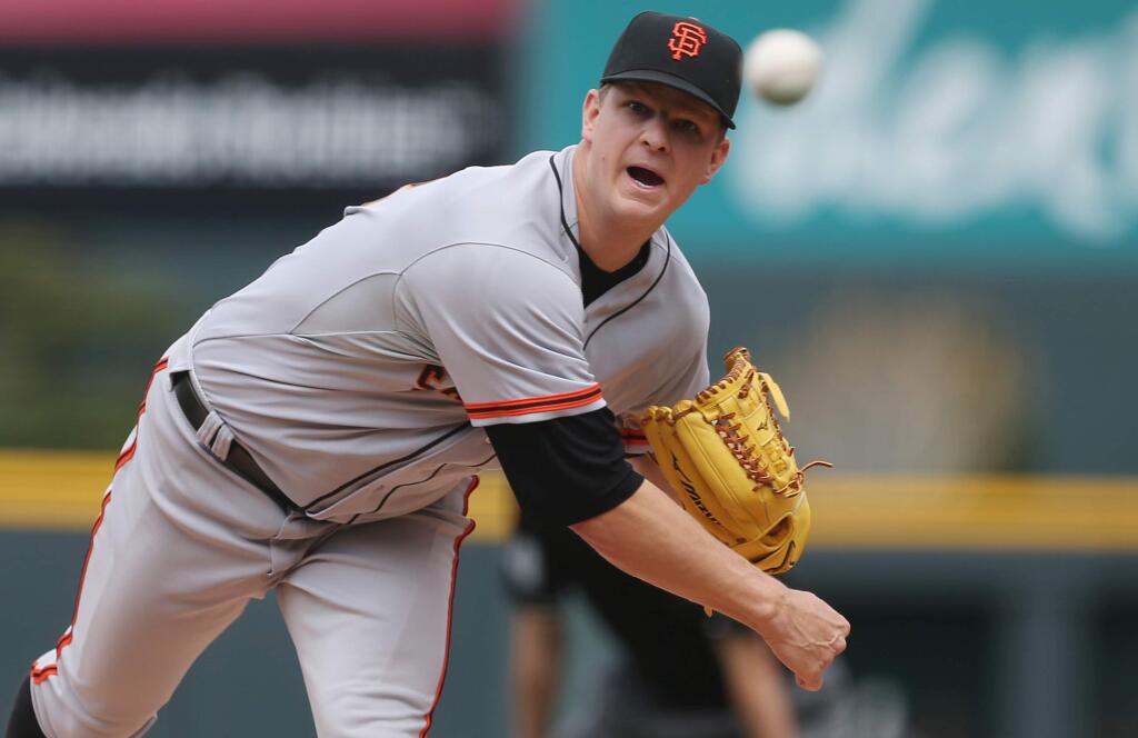 San Francisco Giants starting pitcher Matt Cain works against the Colorado Rockies in the first inning of a baseball game in Denver on Wednesday, April 23, 2014. (AP Photo/David Zalubowski)