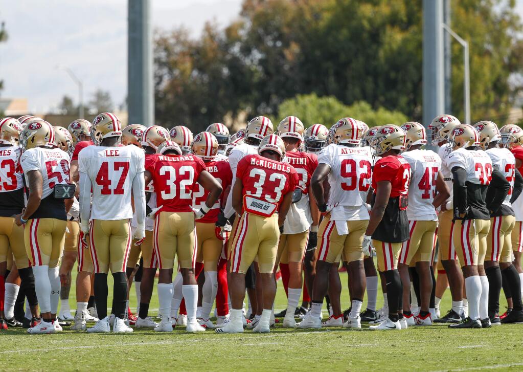 The San Francisco 49ers huddle during practice at the team's headquarters Saturday, July 28, 2018, in Santa Clara. (AP Photo/Tony Avelar)