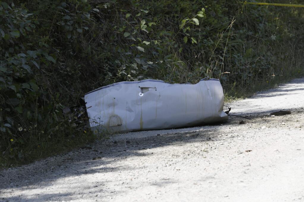 Wreckage from a medical transport plane that crashed is shown on a road east of Crannell, Calif., Friday, July 29, 2016. Authorities found the wreckage of a small medical transport plane with four people aboard and confirmed at least two deaths Friday after the pilot reported smoke filling the cockpit and a search started across a densely forested mountain range in Northern California. (Shaun Walker/The Times-Standard via AP)