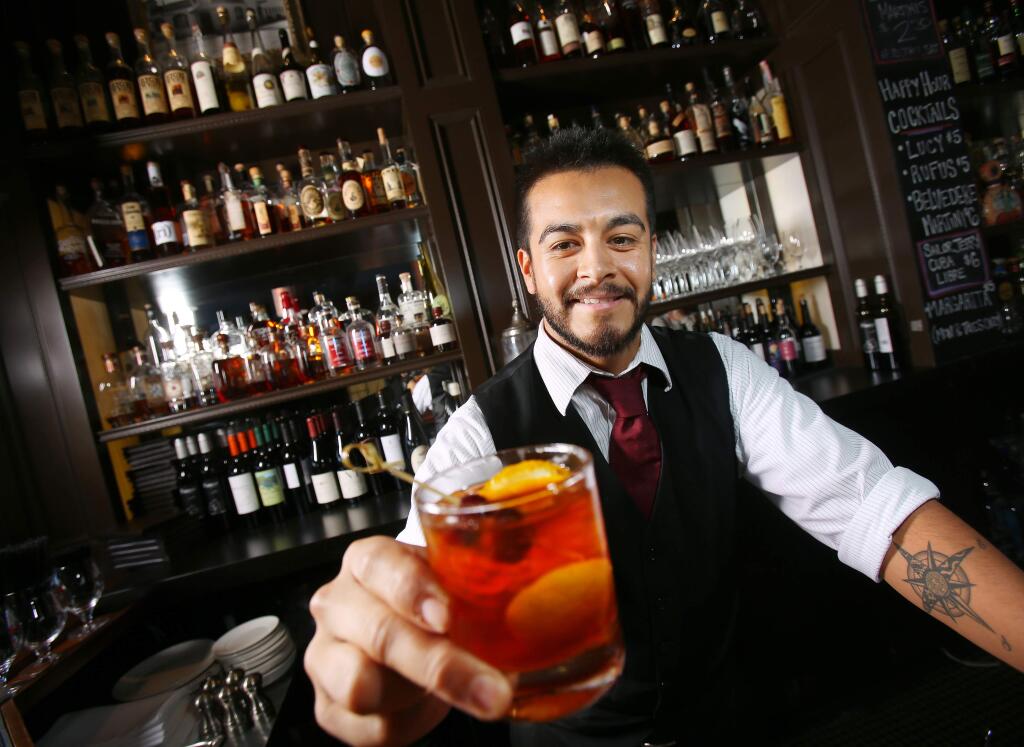 Stark's Steak and Seafood in Santa Rosa. Here, bartender Neil Espinosa serves an Old Fashioned. (Conner Jay/The Press Democrat) See more at BiteClubEats.com.