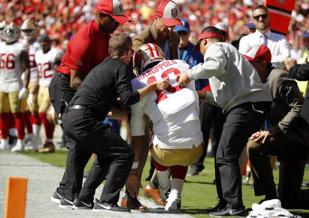 Trainers lift injured San Francisco 49ers quarterback Jimmy Garoppolo, who was hurt after a tackle by Kansas City Chiefs defensive back Steven Nelson during the second half in Kansas City, Mo., Sunday, Sept. 23, 2018. (AP Photo/Charlie Riedel)