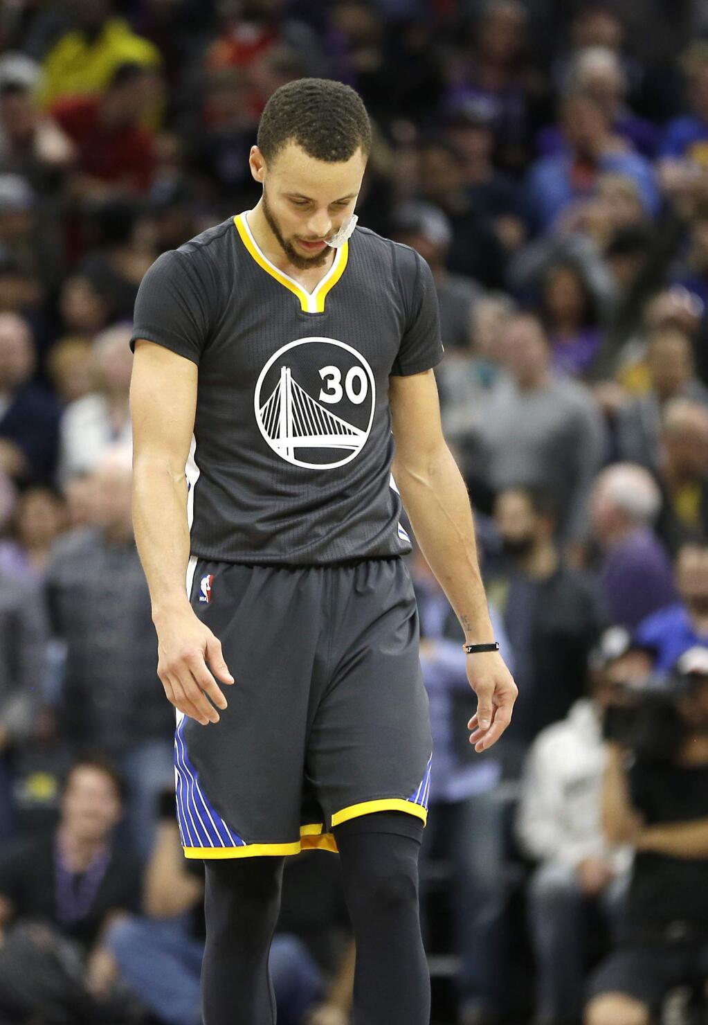Golden State Warriors guard Stephen Curry walks downcourt in the closing moments of the Warriors 109-106 overtime loss to the Sacramento Kings in an NBA basketball game in Sacramento, Calif., Saturday, Feb. 4, 2017. (AP Photo/Rich Pedroncelli)