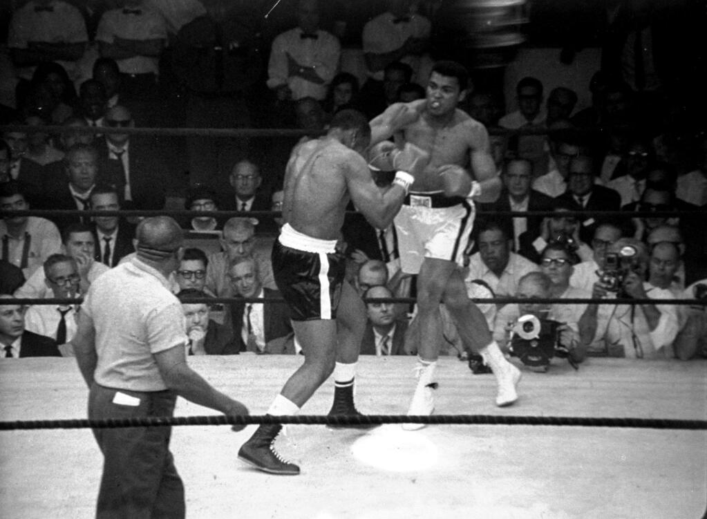 Muhammad Ali lands the 'phantom punch' at 1 min., 43 seconds into the first round to win over Sonny Liston, during their championship bout in Lewiston, Maine, on May 25, 1965. (AP Photo)