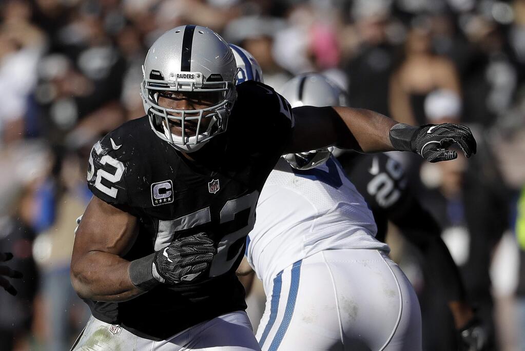 In this Dec. 24, 2016, file photo, Oakland Raiders defensive end Khalil Mack rushes against the Indianapolis Colts during a game in Oakland. The Raiders exercised the fifth-year option of Mack, the team announced Thursday, April 20, 2017. The reigning Defensive Player of the Year has compiled double-digit sacks each of the past two seasons. (AP Photo/Marcio Jose Sanchez, File)
