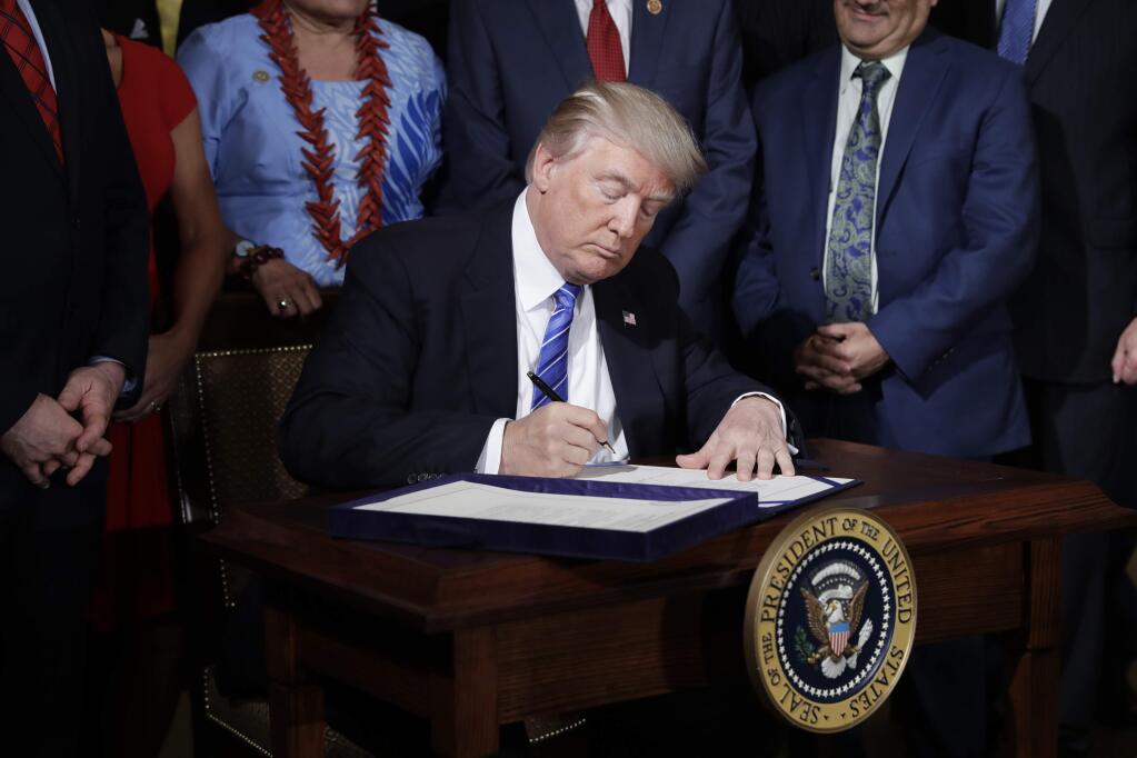 President Donald Trump signs the 'Department of Veterans Affairs Accountability and Whistleblower Protection Act of 2017' in the East Room of the White House, Friday, June 23, 2017, in Washington. (AP Photo/Evan Vucci)