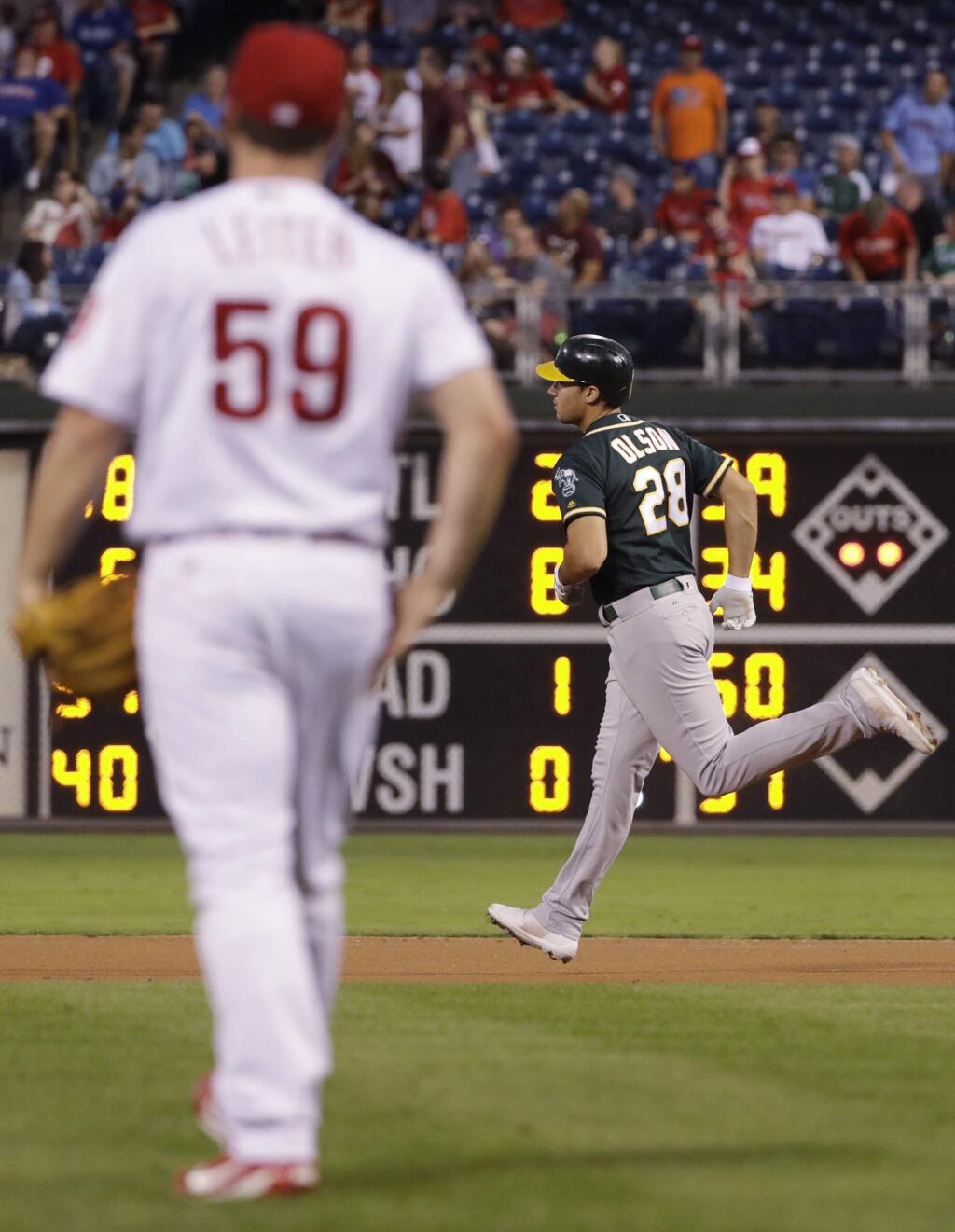 Oakland Athletics' Matt Olson, right, rounds the bases after hitting a two-run home run off Philadelphia Phillies starting pitcher Mark Leiter Jr. during the first inning of a baseball game, Friday, Sept. 15, 2017, in Philadelphia. (AP Photo/Matt Slocum)