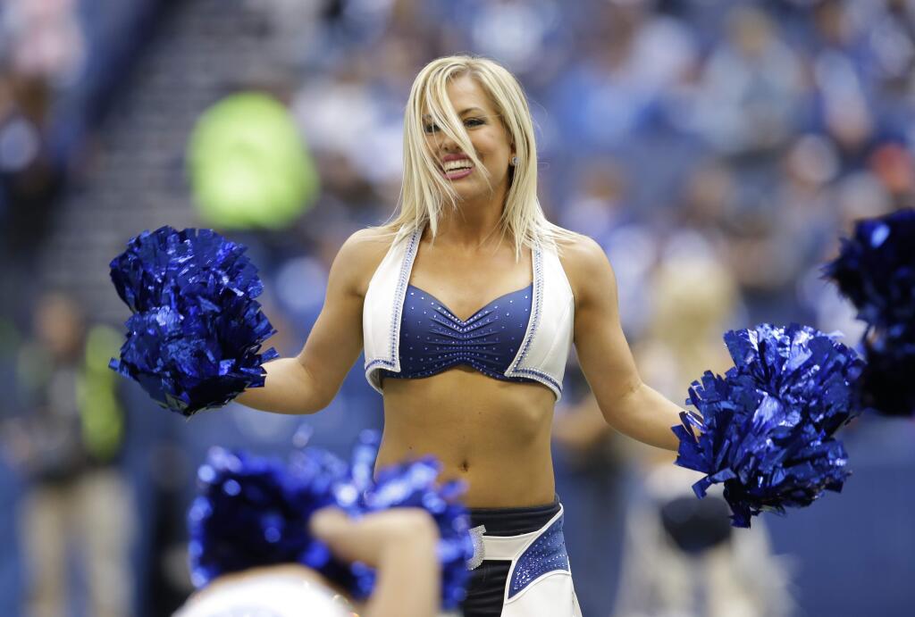 An Indianapolis Colts cheerleader cheers during the first half of an NFL football game between the Indianapolis Colts and the Cincinnati Bengals Sunday, Oct. 19, 2014, in Indianapolis. (AP Photo/AJ Mast)