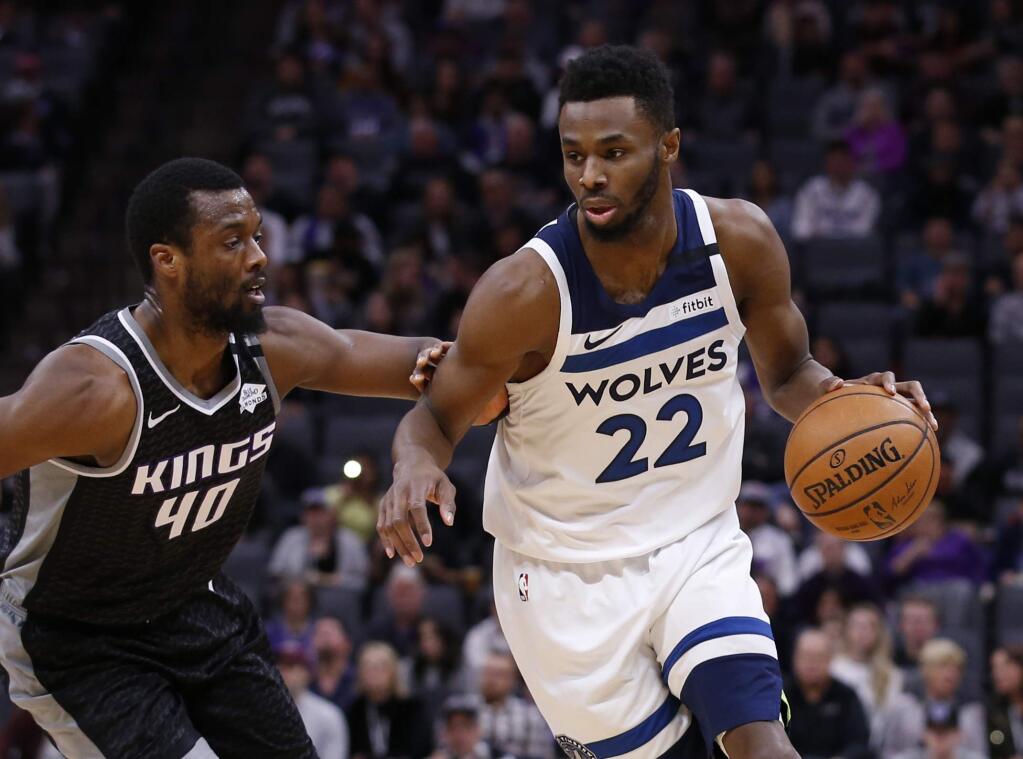 Minnesota Timberwolves guard Andrew Wiggins, right, drives against Sacramento Kings forward Harrison Barnes, left, during the first quarter Monday, Feb. 3, 2020. (AP Photo/Rich Pedroncelli)