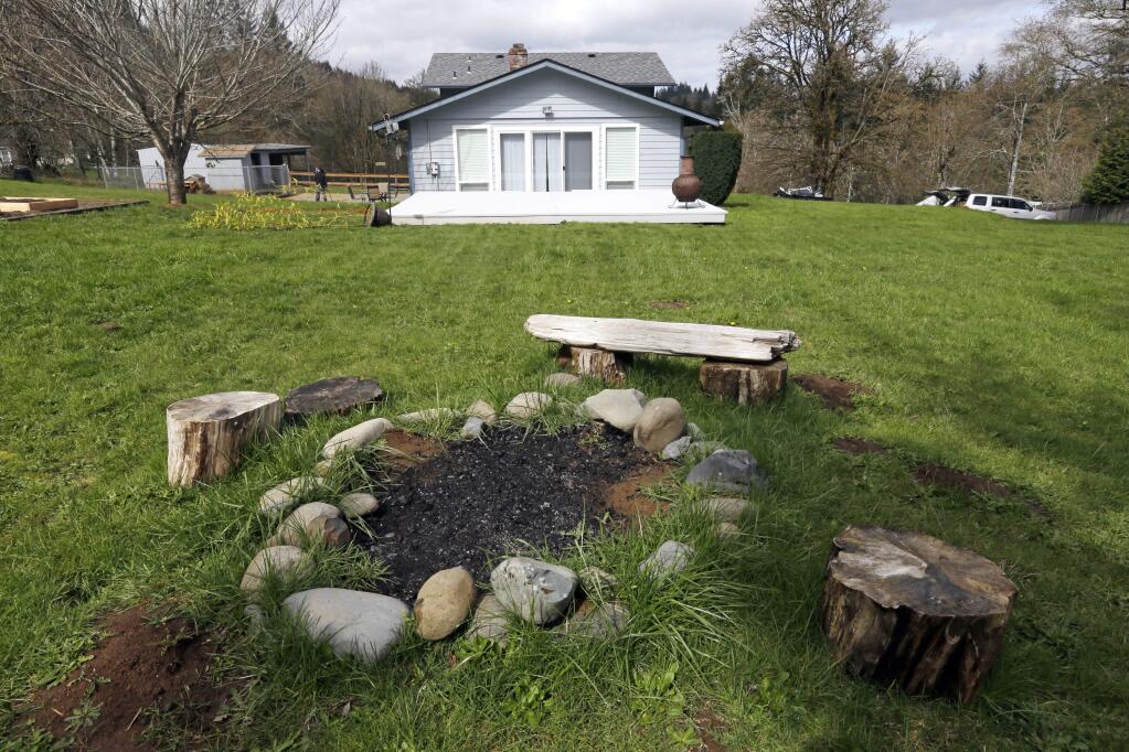 This photo taken Wednesday, March 28, 2018, shows a backyard fire pit at the house in Woodland, Wash., where the Hart family lived. (AP Photo/Don Ryan)