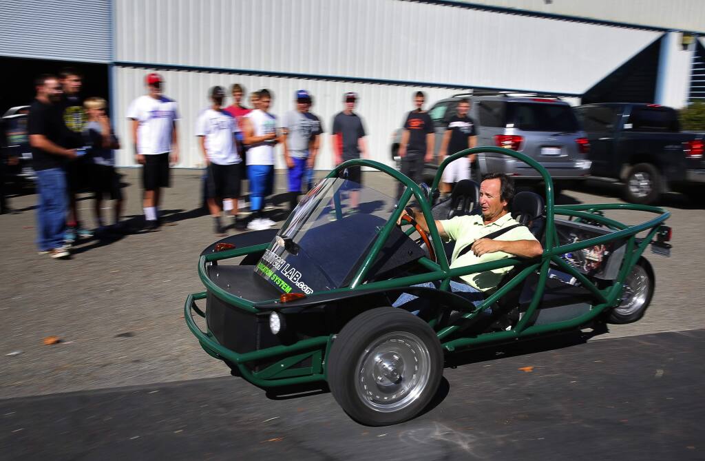 Peter Oliver, co-founder of Switch Vehicles, demonstrates his electric vehicle to beginning automotive technology students from Analy High School, at The SWITCH Lab, in Sebastopol, on Wednesday, October 21, 2015. Students in the class will be building an electric vehicle later this schoolyear. Sonoma Clean Power has been a supporter of the lab. (Christopher Chung/ The Press Democrat)