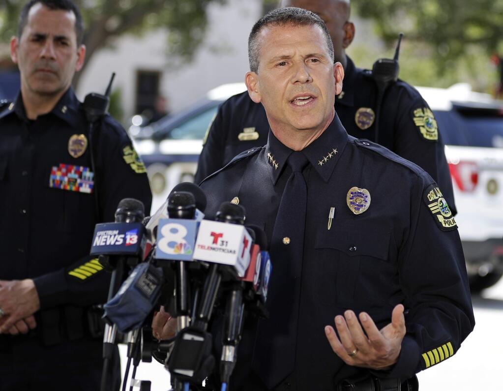 Orlando Police Chief John Mina answers questions at an afternoon news conference during a hostage standoff Monday, June 11, 2018, in Orlando, Fla. Police said a man suspected of battering his girlfriend shot a police officer late Sunday and barricaded himself inside an apartment with several young children. (AP Photo/John Raoux)