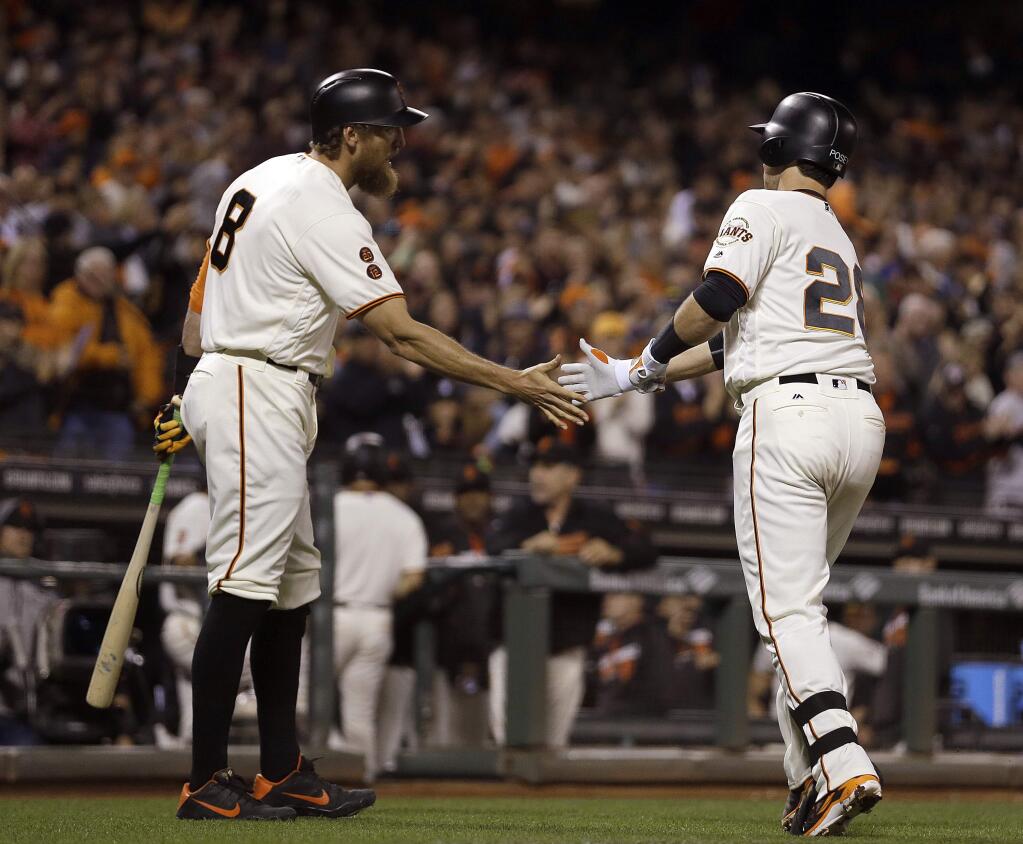 San Francisco Giants' Buster Posey, right, is congratulated by Hunter Pence (8) after hitting a home run off Colorado Rockies pitcher German Marquez in the fifth inning of a baseball game, Tuesday, Sept. 27, 2016, in San Francisco. (AP Photo/Ben Margot)