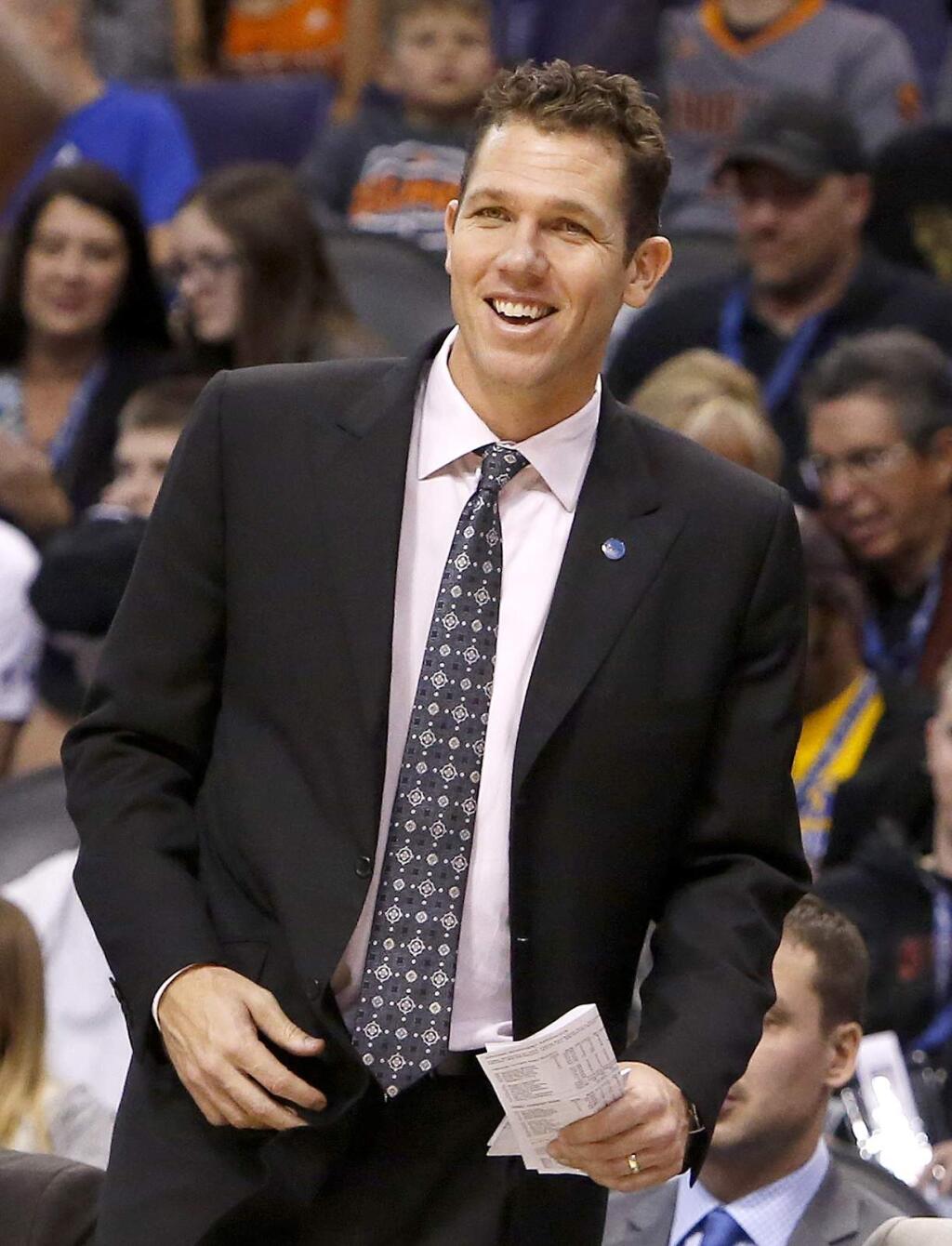 FILE - In this Nov. 27, 2015, file photo, Golden State Warriors interim head coach Luke Walton smiles in the first quarter during an NBA basketball game against the Phoenix Suns, in Phoenix. Walton has the Warriors off to record start even if he doesn't get official credit for it. (AP Photo/Rick Scuteri, File)
