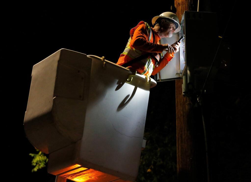 A PG&E crew works to reenergize power lines the public safety power shutoff this month. (ALVIN JORNADA / The Press Democrat)