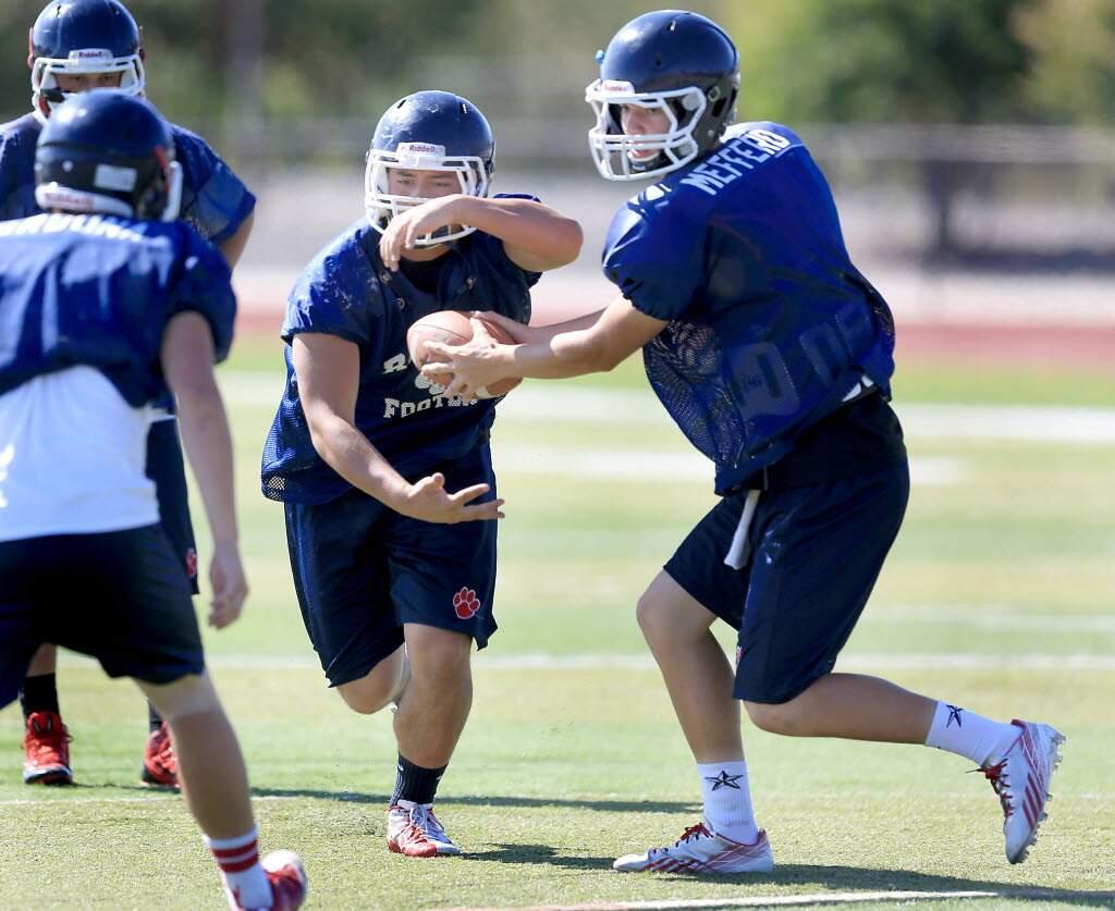 Rancho Cotate quarterback Gunner Mefferd works on his game at a preseason practice last August. (Press Democrat / Kent Porter)
