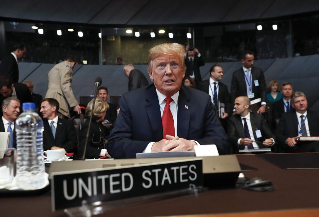 U.S. President Donald Trump takes his seat as he attends the multilateral meeting of the North Atlantic Council, Wednesday, July 11, 2018 in Brussels, Belgium. (AP Photo/Pablo Martinez Monsivais/pool)