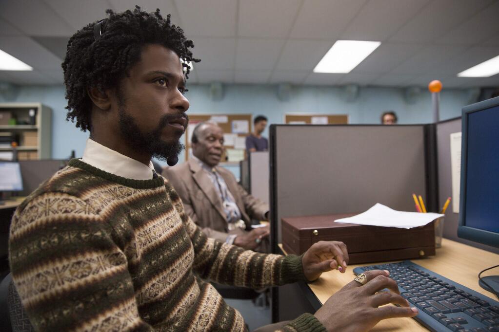 This image released by Annapurna Pictures shows Lakeith Stanfield, foreground, and Danny Glover in a scene from the film, 'Sorry To Bother You.' (Annapurna Pictures via AP)