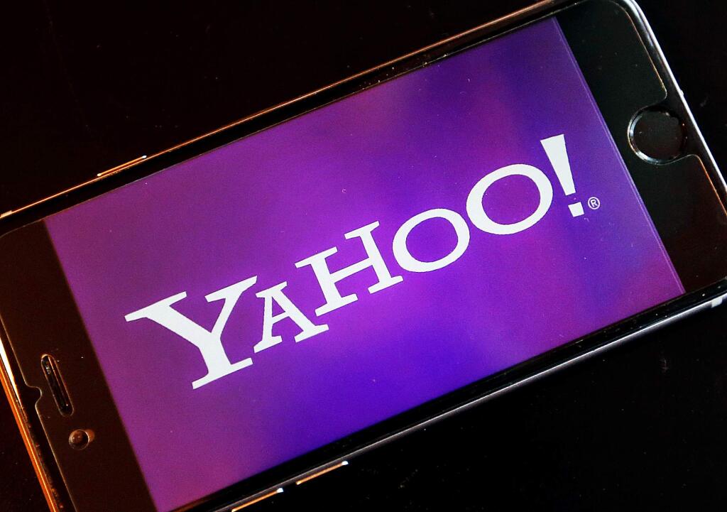 FILE - In this Dec. 15, 2016, file photo, the logo of Yahoo appears on a smartphone in Frankfurt, Germany. (AP Photo/Michael Probst, File)