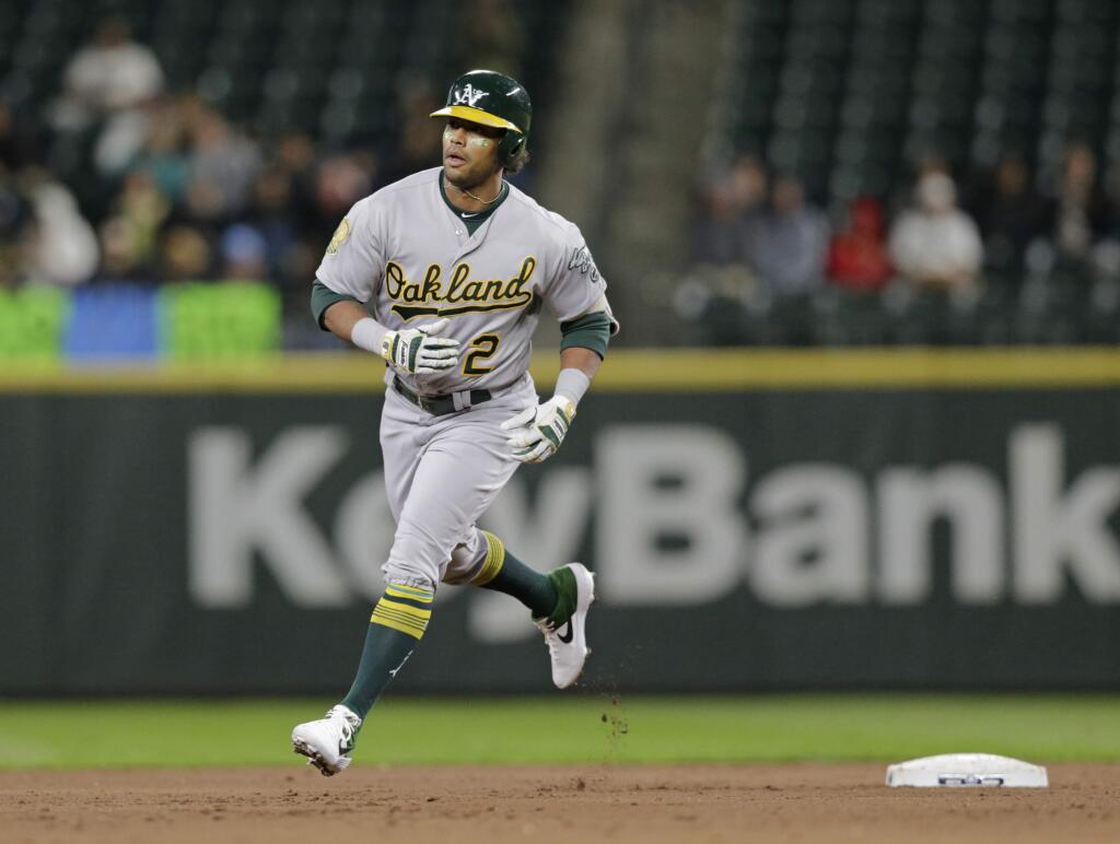 In this Sept. 24, 2018, file photo, the Oakland Athletics' Khris Davis rounds the bases after hitting a home run against the Seattle Mariners. (AP Photo/John Froschauer,File)