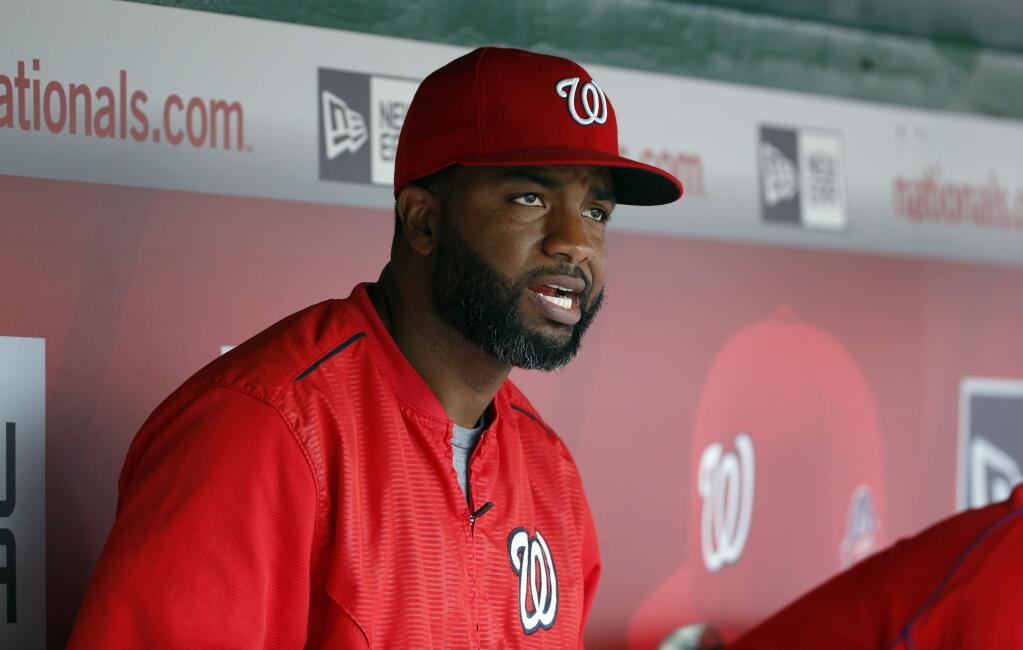 Denard Span (2) sits in the Washington Nationals dugout during a game against the Miami Marlins at Nationals Park, Sunday, Aug. 30, 2015, in Washington. (AP Photo/Alex Brandon)