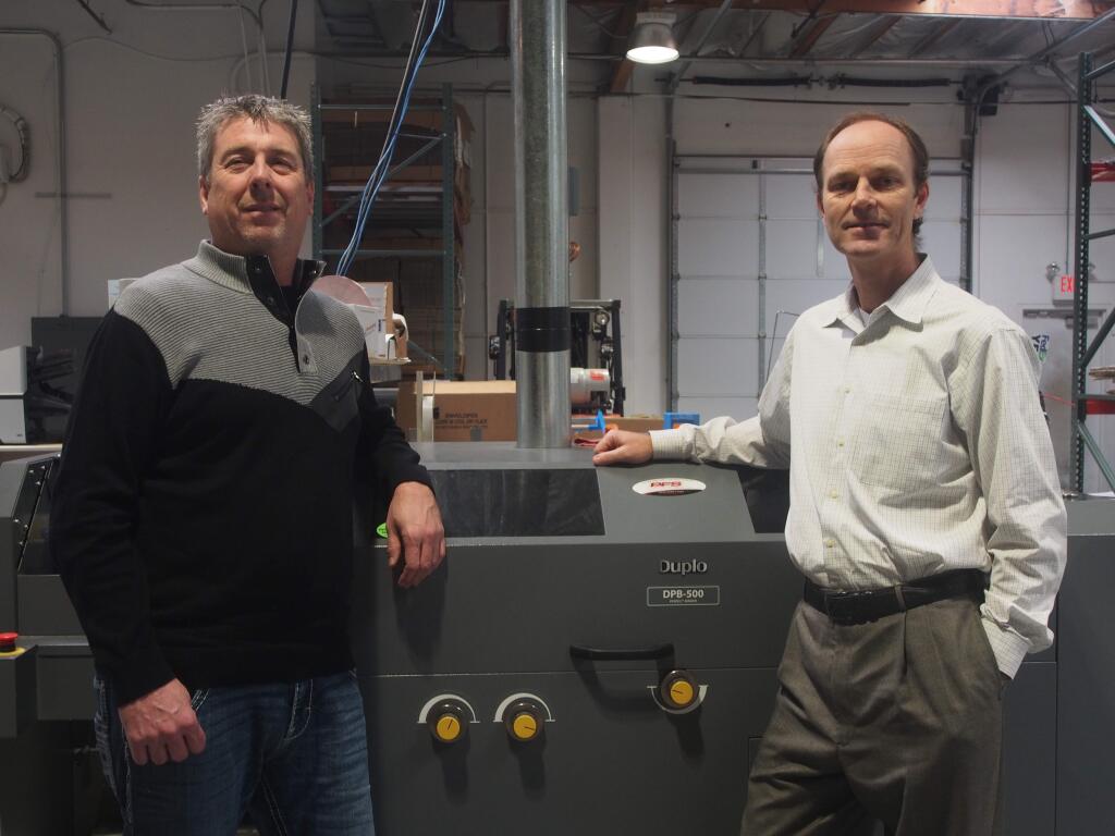 Greg Johnston, left, head of AJ Printing & Graphics, and Eric Janssen, owner of ChromaGraphics, pose in AJ Printing's Santa Rosa facility on Wednesday, Feb. 20, 2019. ChromaGraphics of Santa Rosa merged with AJ Printing on Feb. 1, 2019, and is relocating equipment to its facility. (Chase DiFeliciantonio / North Bay Business Journal)