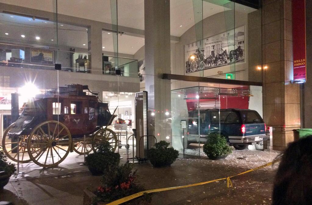 A vehicle is seen smashed into the window of the Wells Fargo History Museum in downtown San Francisco, Tuesday, Jan. 27, 2015. (AP Photo/Kristin Bender)