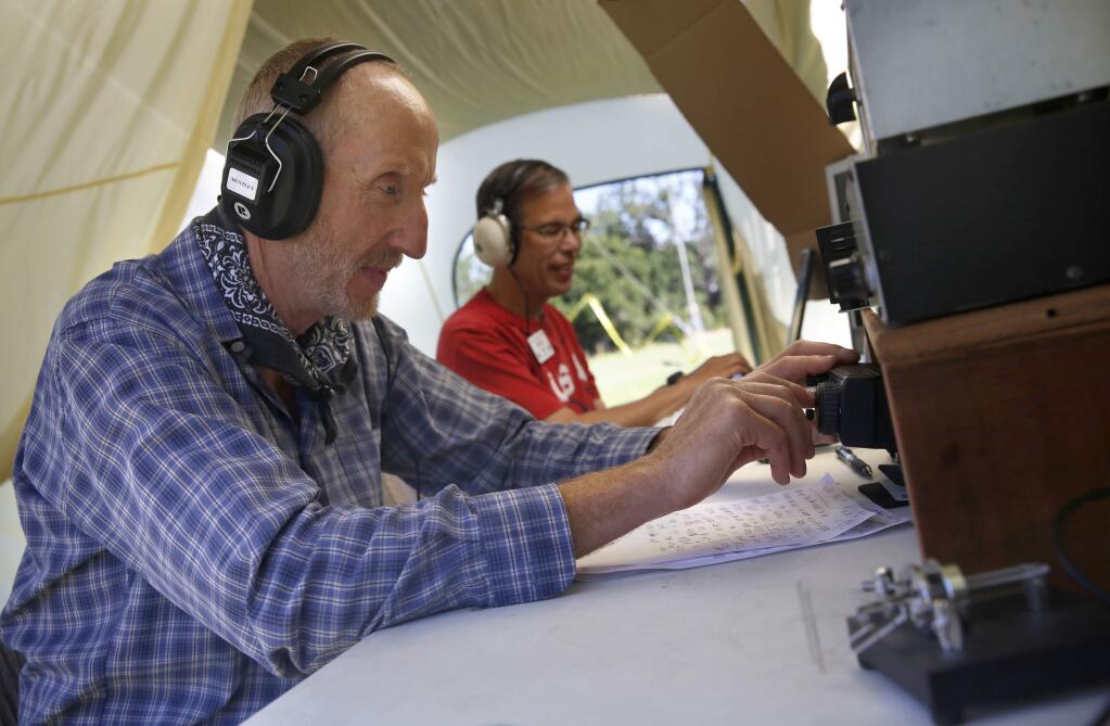 Frank Oddy, left, and Bob Hickman transmit and receive Morse code to an operator in Virginia during the amateur radio field day at Youth Community Park on Sunday, June 26, 2016 in Santa Rosa, California . (BETH SCHLANKER/ The Press Democrat)