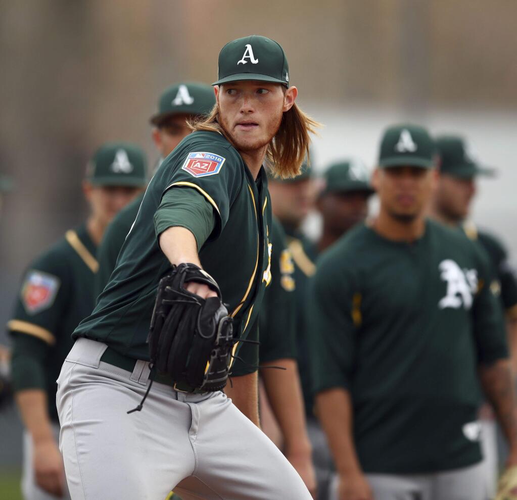 The Oakland Athletics' A.J. Puk participates in a spring training drill on Friday, Feb. 16, 2018 in Mesa, Ariz. (AP Photo/Ben Margot)