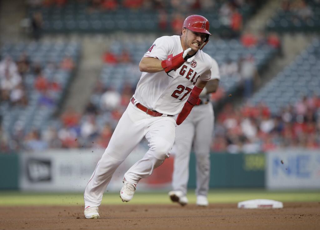 In this July 30, 2019, file photo, the Los Angeles Angels' Mike Trout rounds second to advance to third from first on a single by Shohei Ohtani against the Detroit Tigers during the first inning in Anaheim. (AP Photo/Alex Gallardo, File)
