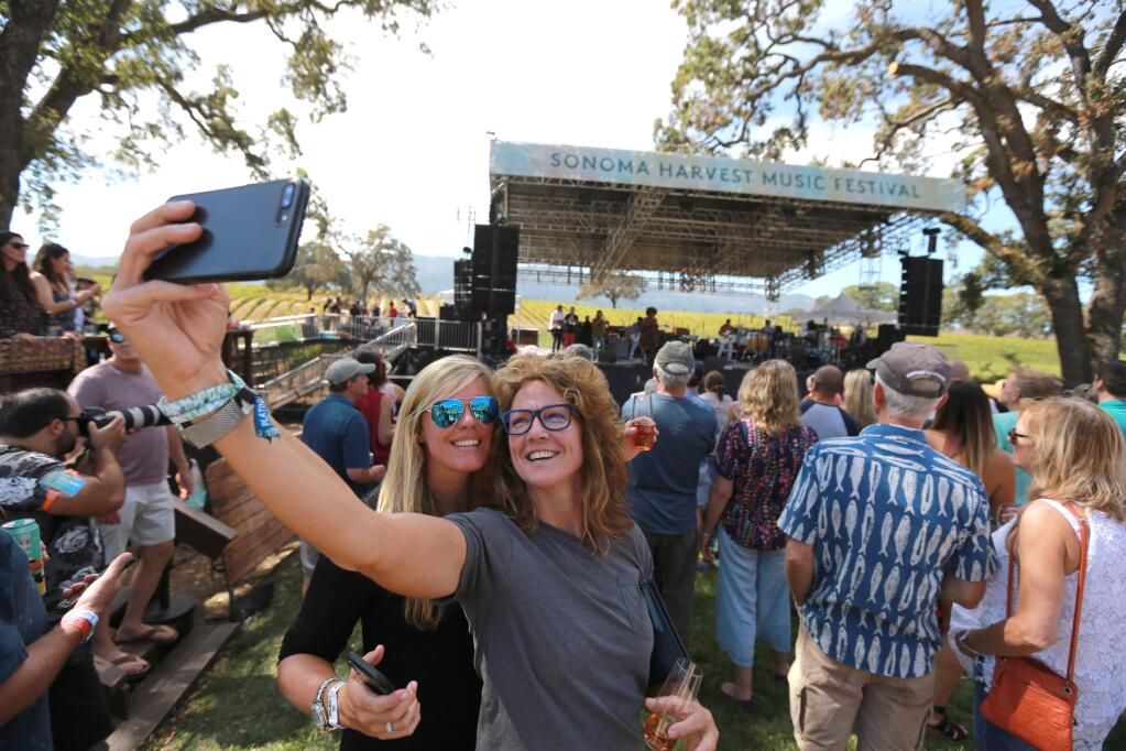 Laurie Davidson-Smith, left, and Michelle Smith, both from Treasure Island, Florida, pose for a picture during the 2018 Sonoma Harvest Music Festival at B.R. Cohn Winery in Glen Ellen. The event returns to the winery Saturday and Sunday, Oct. 8-9. (Photo by Darryl Bush / For The Press Democrat)