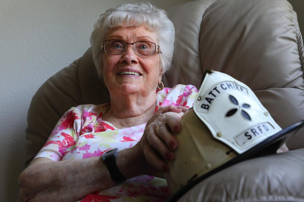 A new Santa Rosa firefighter, Scott Moder, gave 98-year-old Jo Miller the helmet that belonged to her late husband, Ben Miller, a Santa Rosa Fire Department battalion chief that retired in 1988.(Christopher Chung/ The Press Democrat)